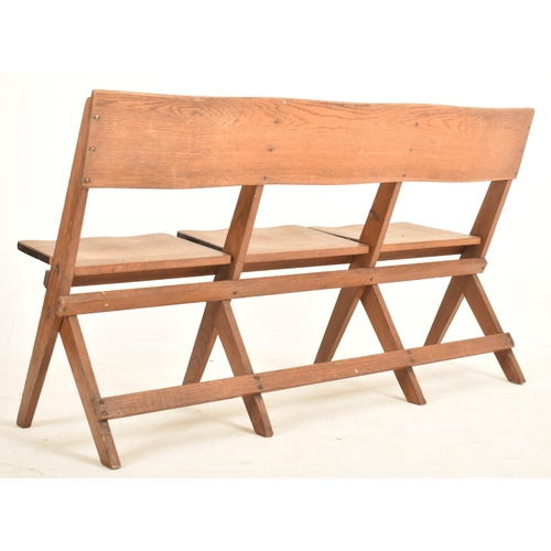 317 - An early 20th century 1920s oak & elm theatre three-seater bench. The bench having straight back res... 