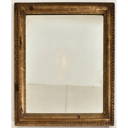 318 - A 19th century giltwood and gesso framed hanging mirror. The mirror of rectangular form having a cus... 