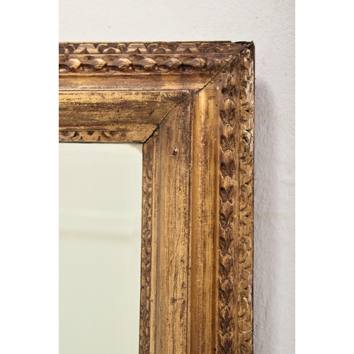 318 - A 19th century giltwood and gesso framed hanging mirror. The mirror of rectangular form having a cus... 