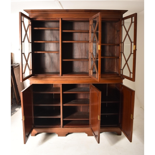 332 - An Edwardian mahogany astragal glazed library bookcase cabinet. The bookcase having a flyaway cornic... 