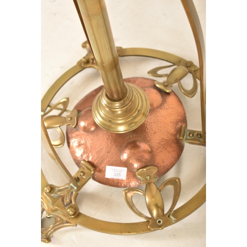 335 - An early 20th century circa 1905 Arts and Crafts style hammered copper and brass standard lamp. The ... 