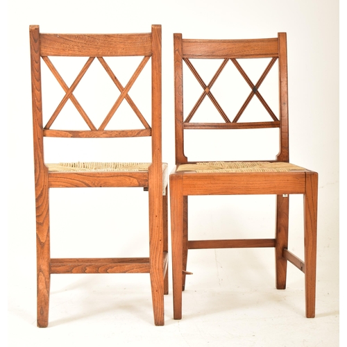 352 - A set of eight Regency early 19th century elm & rush seat dining chairs with carvers. Each chair hav... 