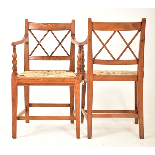 352 - A set of eight Regency early 19th century elm & rush seat dining chairs with carvers. Each chair hav... 