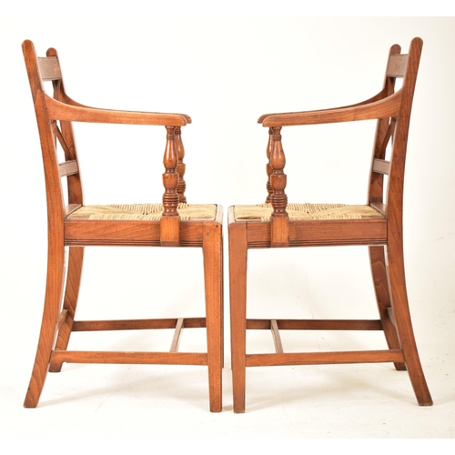 352 - A set of eight Regency early 19th century elm & rush seat dining chairs with carvers. Each chair hav... 