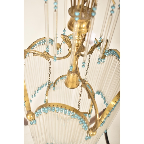 356 - An Art Deco inspired 20th century gilt metal & glass rod ceiling chandelier light. The chandelier ha... 