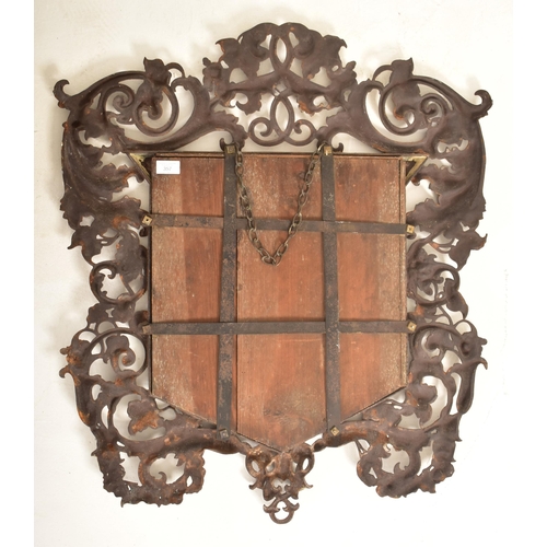 357 - A Victorian 19th century Rococo inspired cast iron wall hanging mirror. The mirror having intricatel... 