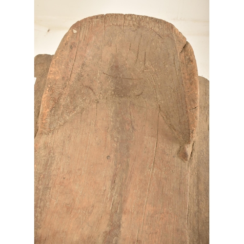 364 - An West African Ivory Coast tribal Senufo carved wood day bed / bench. The bed having a raised head ... 