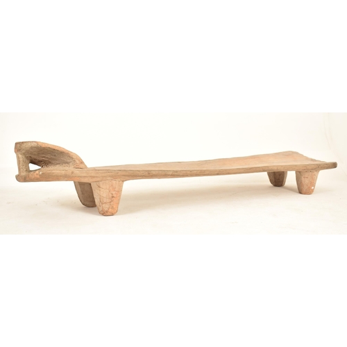 364 - An West African Ivory Coast tribal Senufo carved wood day bed / bench. The bed having a raised head ... 