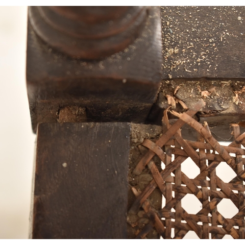 367 - A Carolean 17th century carved walnut & wicker hall chair. The chair having urn shaped finials atop ... 