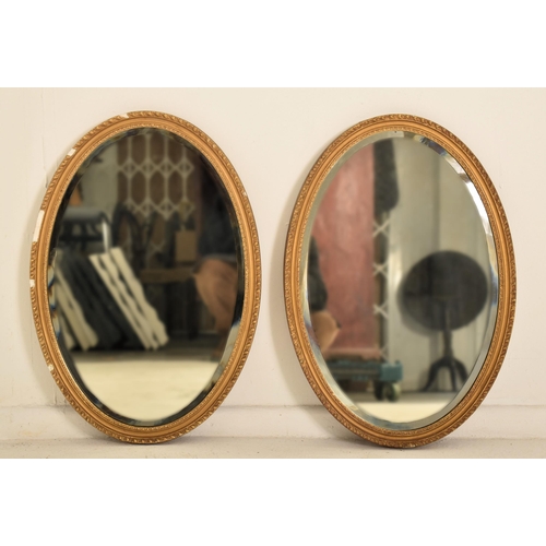 371 - A pair of late Victorian late 19th century gilt gesso & wood oval wall hanging mirrors. Each mirror ... 