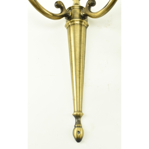 372 - A set of four Italian manner 20th century brass twin arm wall sconces lights. Each sconce having a c... 