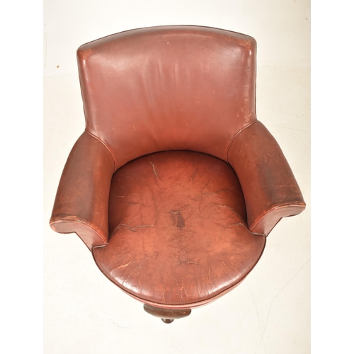 375 - An Edwardian / 1920s leather swivel office desk armchair. The chair having a curved backrest with sc... 