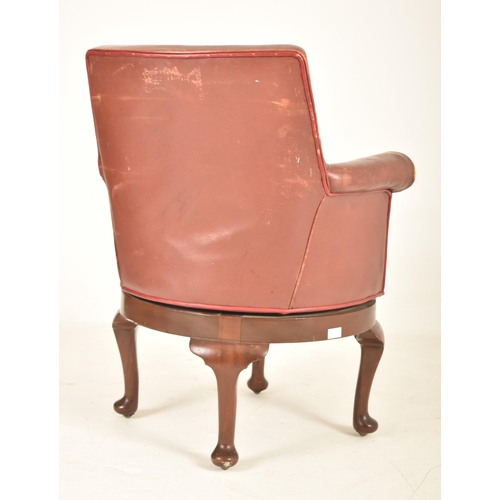 375 - An Edwardian / 1920s leather swivel office desk armchair. The chair having a curved backrest with sc... 