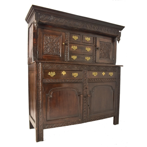 387 - A late 17th century / early 18th century oak court cupboard. The cupboard having a pediment atop wit... 