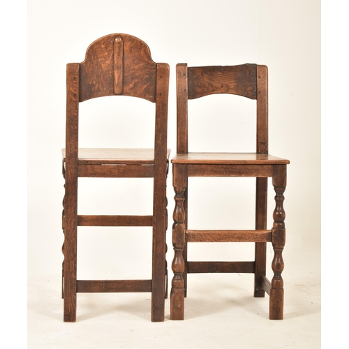 389 - A pair of 19th century oak and elm correctional chairs. Each with panel back and seat rests with eac... 