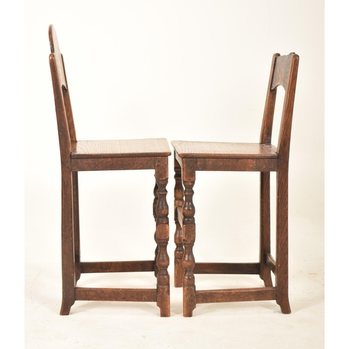 389 - A pair of 19th century oak and elm correctional chairs. Each with panel back and seat rests with eac... 