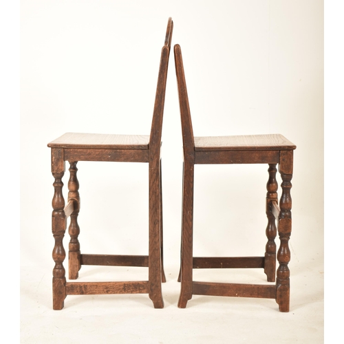 389 - A pair of 19th century oak and elm correctional chairs. Each with panel back and seat rests with eac... 