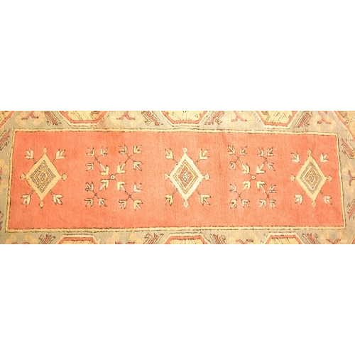 393 - A 20th century Turkish machine woven Milas wool carpet floor rug. The rug of rectangular form having... 