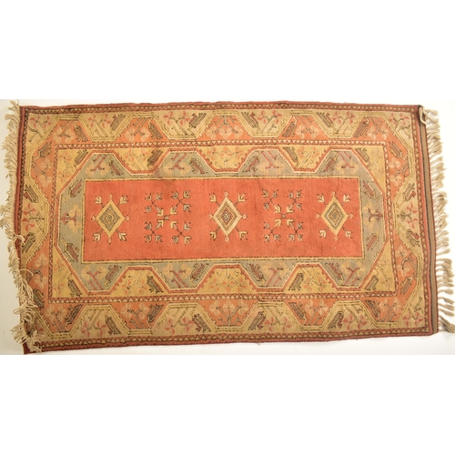 393 - A 20th century Turkish machine woven Milas wool carpet floor rug. The rug of rectangular form having... 