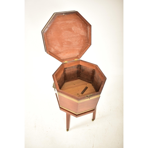 398 - A George III early 19th century mahogany & brass bound wine cooler bucket on feet. The cooler having... 