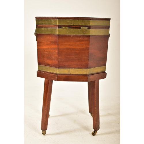 398 - A George III early 19th century mahogany & brass bound wine cooler bucket on feet. The cooler having... 