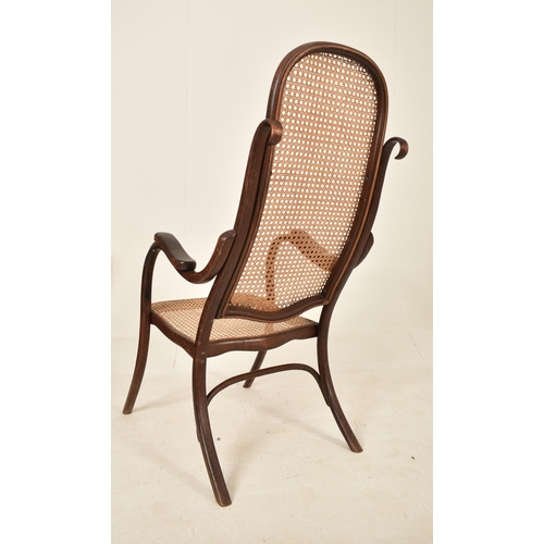 251 - Thonet, Germany - An early 20th century bentwood & cane fireside high back armchair. The chair havin... 