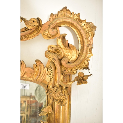 254 - A large Rococo inspired 19th century gilt wood & gesso overmantel mirror. The mirror having a intric... 