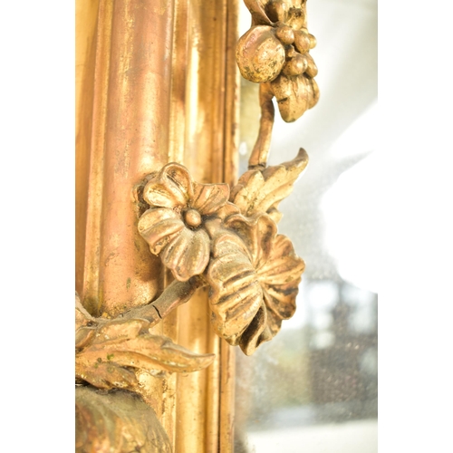 254 - A large Rococo inspired 19th century gilt wood & gesso overmantel mirror. The mirror having a intric... 