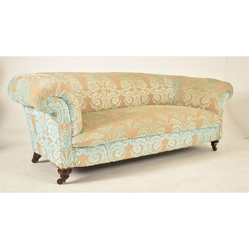 258 - Two 19th century chesterfield sofa settees having scrolled armrests and being raised over turned mah... 