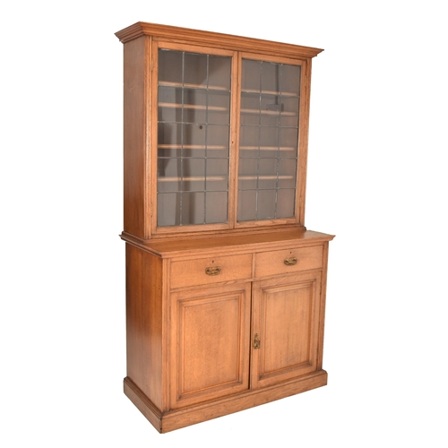 262 - A matching pair of late 19th century Victorian oak bookcase cabinets. Each having led lined glazed d... 