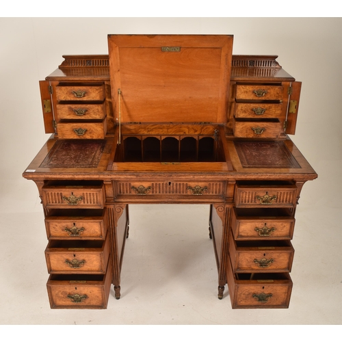 263 - A 19th century Victorian Maple & Co walnut Dickens writing table desk. The desk having a raised gall... 