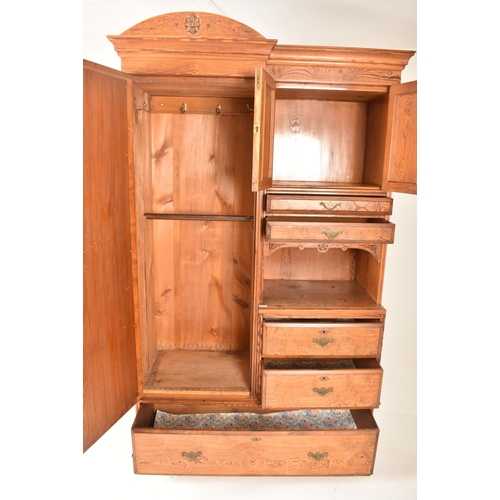 271 - A Victorian 19th century Arts & Crafts pitch pine Compactum double wardrobe. The wardrobe having a h... 