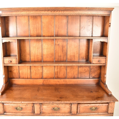 272 - A George III Revival Ipswich oak Welsh dresser. The dresser having a pediment atop over two panelled... 