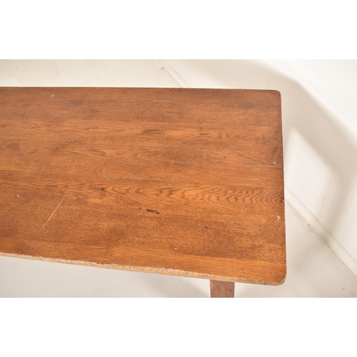 278 - An early 20th century elm wood plank top refectory dining table. The table having a two plank top ra... 