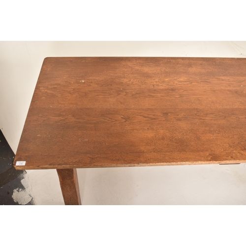 278 - An early 20th century elm wood plank top refectory dining table. The table having a two plank top ra... 