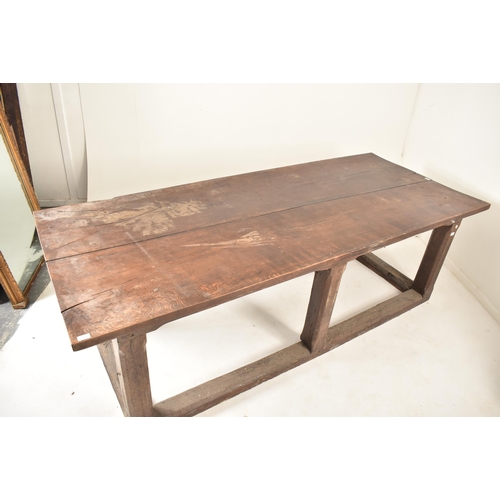 285 - An 18th century oak refectory farmhouse plank top peg jointed dining table. The table having a two p... 