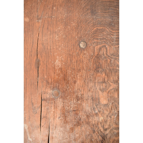 285 - An 18th century oak refectory farmhouse plank top peg jointed dining table. The table having a two p... 