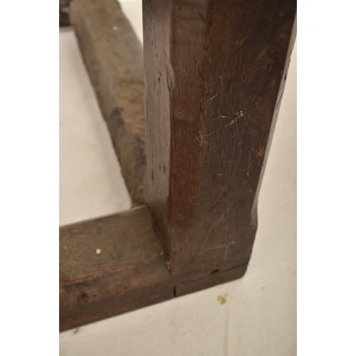 285 - An 18th century oak refectory farmhouse plank top peg jointed dining table. The table having a two p... 