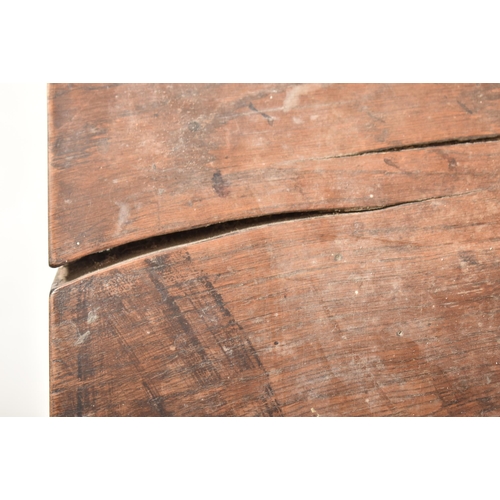 285 - An 18th century oak refectory farmhouse plank top peg jointed dining table. The table having a two p... 