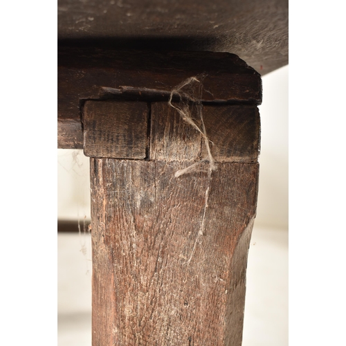 285 - An 18th century oak refectory farmhouse plank top peg jointed dining table. The table having a two p... 