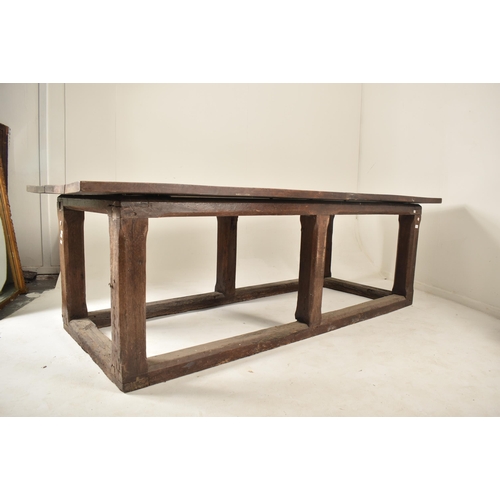 285 - An 18th century oak refectory farmhouse plank top peg jointed dining table. The table having a two p... 