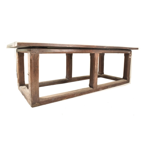 285 - An 18th century oak refectory farmhouse plank top peg jointed dining table. The table having a two p... 