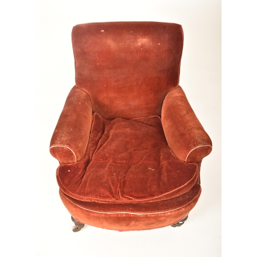 292 - A Victorian 19th century velvet upholstered armchair in the manner of Howard & Sons. The armchair ha... 