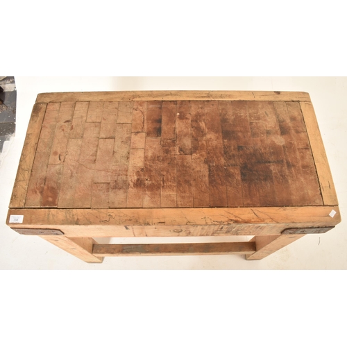 298 - An Edwardian 20th century beech & pine butcher's block. The table having a rectangular top with meta... 