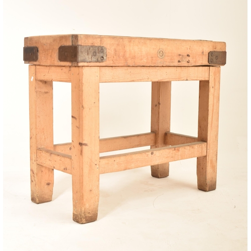 298 - An Edwardian 20th century beech & pine butcher's block. The table having a rectangular top with meta... 