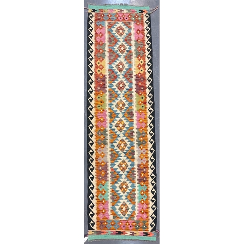 592 - A 20th century Anatolian Turkish Kilim floor carpet runner rug. The runner having a central series o... 