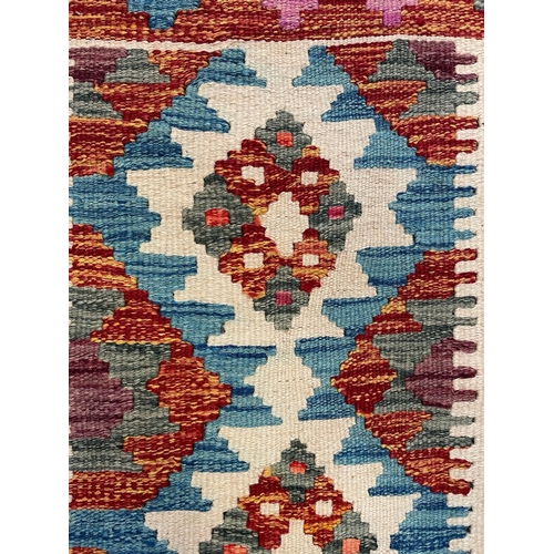 592 - A 20th century Anatolian Turkish Kilim floor carpet runner rug. The runner having a central series o... 