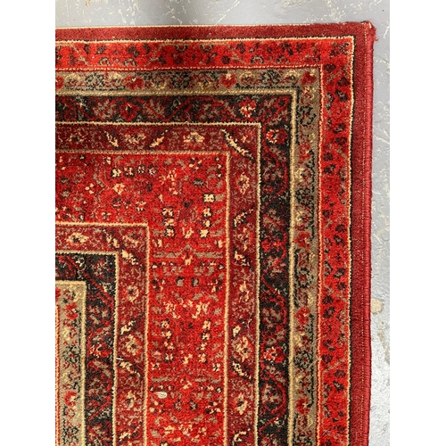 341 - A Royal Keshan pure new wool pile Afghan floor carpet rug. The rug of red ground with central panel ... 