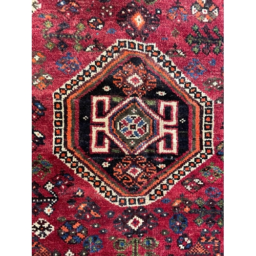 412 - A early 20th century South West Persian Islamic Qashgai floor carpet rug. The rug having a central g... 