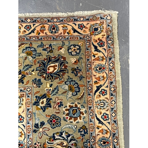 421 - An early 20th century Central Persian Islamic Kashan floor carpet rug. The rug having a mint green g... 